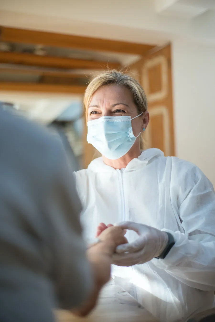 A smiling healthcare worker in a mask